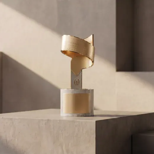 Gold spiral ribbon trophy on a cylindrical base