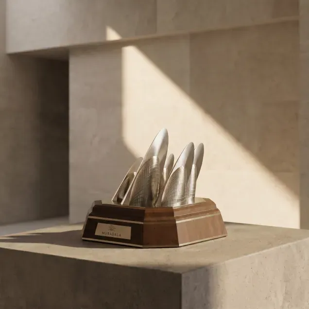 Silver sail-shaped award on a wooden base